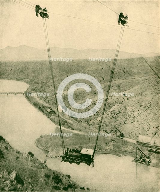 'A Contractor's Engine Being Swung Across A Canyon, Rio Grande River, New Mexico', 1930. Creator: Unknown.