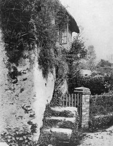 A cottage with an ancient upping stock Cockington, Devon, 1924-1926.Artist: HJ Smith