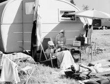 A couple by their caravan at the campsite, Trelleborg, Sweden, 1950s. Creator: Unknown