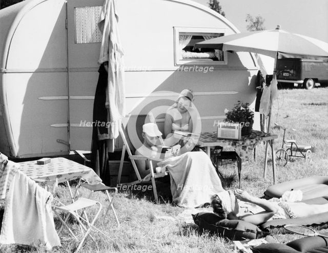 A couple by their caravan at the campsite, Trelleborg, Sweden, 1950s. Creator: Unknown.