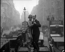 A Couple Dancing the Charleston on the Top of a Car Driving Down a London Street, 1926. Creator: British Pathe Ltd