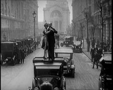 A Couple Dancing the Charleston on the Top of a Car Driving Down a London Street, 1926. Creator: British Pathe Ltd