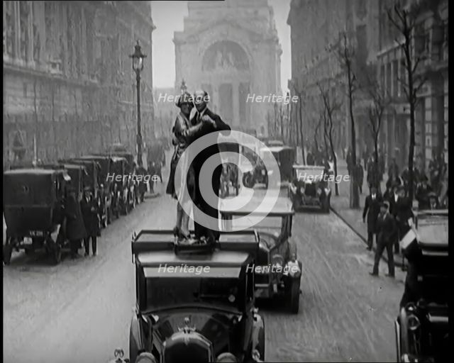 A Couple Dancing the Charleston on the Top of a Car Driving Down a London Street, 1926. Creator: British Pathe Ltd.