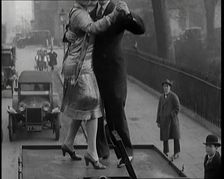 A Couple Dancing the Charleston on the Top of a Car Driving Down a London Street, 1926. Creator: British Pathe Ltd