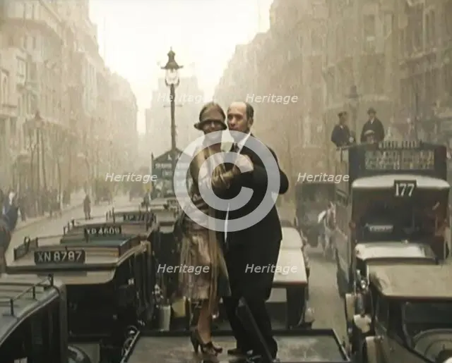 A Couple Dancing the Charleston on the Top of a Car Driving Down a London Street, 1926. Creator: British Pathe Ltd.