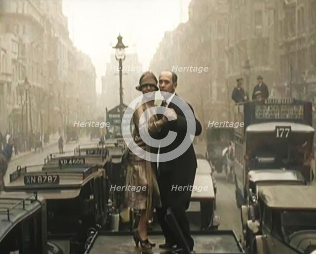 A Couple Dancing the Charleston on the Top of a Car Driving Down a London Street, 1926. Creator: British Pathe Ltd.