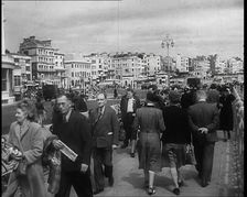 A Cloudy Day as Male and Female Pedestrians are Walking on the Promenade at Brighton..., 1939. Creator: British Pathe Ltd
