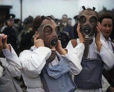 A Close up of Three Female Civil Defence Volunteers in White Boiler Suits Putting on Gas..., 1938. Creator: British Pathe Ltd