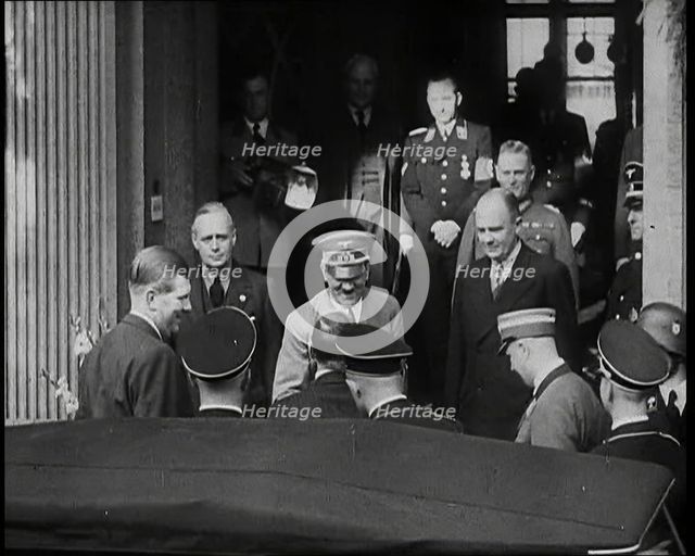 A Close up of Adolf Hitler, the German Leader, on the Front Steps of a Building Leaning..., 1938. Creator: British Pathe Ltd.