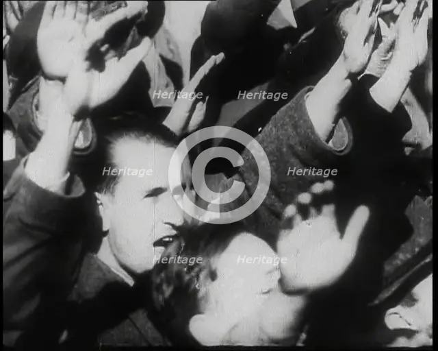 A Close up of Austrian Civilians Performing the German Nazi Salute, 1938. Creator: British Pathe Ltd.