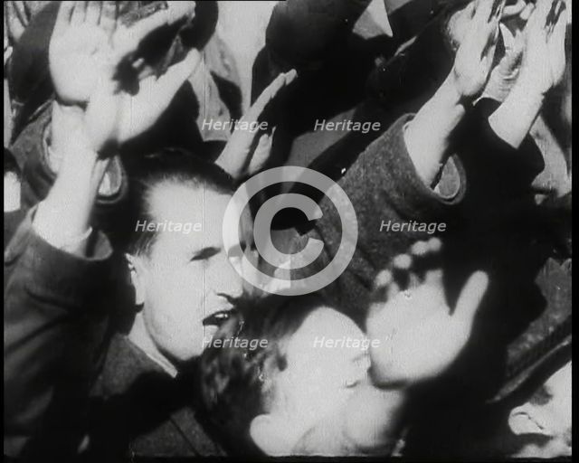 A Close up of Austrian Civilians Performing the German Nazi Salute, 1938. Creator: British Pathe Ltd.