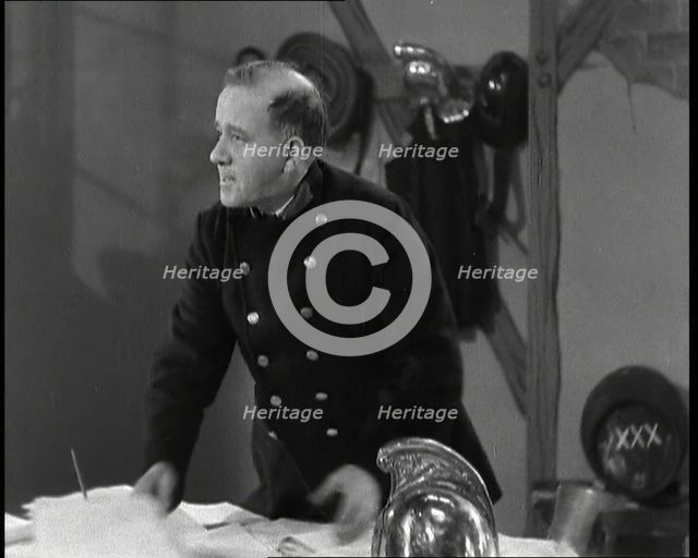 A Close up of Comedian Robb Wilton on Set Playing a Fire Brigade Officer and Standing at a..., 1938. Creator: British Pathe Ltd.