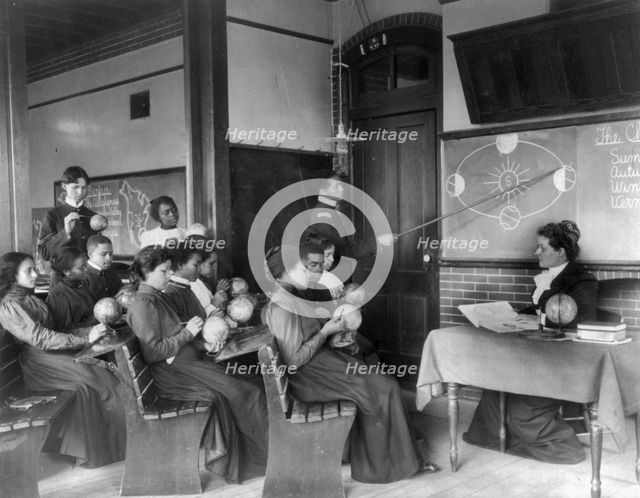 A class in mathematical geography studying earth's rotation..., Hampton Institute, Virginia, 1899. Creator: Frances Benjamin Johnston.