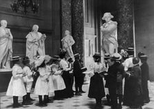 A class of the 6th Division in Statuary Hall, U.S. Capitol, (1899?). Creator: Frances Benjamin Johnston