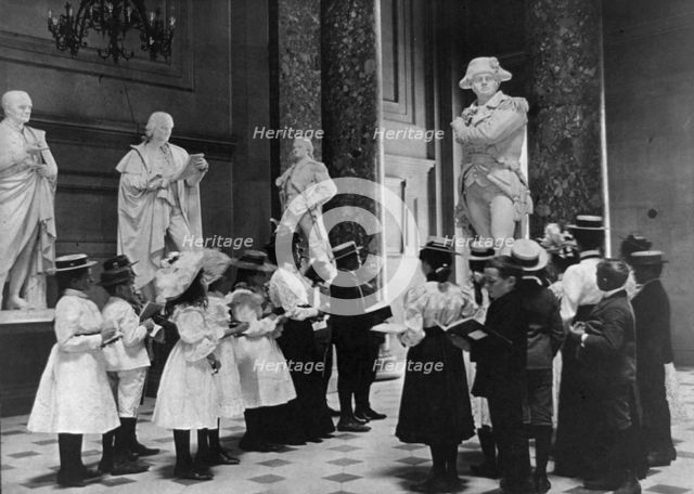 A class of the 6th Division in Statuary Hall, U.S. Capitol, (1899?). Creator: Frances Benjamin Johnston.