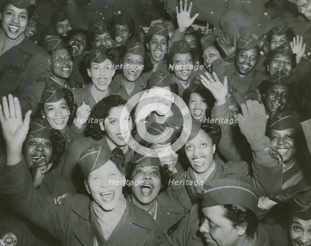 A crowd of African American Women's Army Corps members waving at the camera..., 1946. Creator: Unknown.