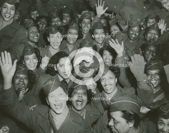 A crowd of African American Women's Army Corps members waving at the camera..., 1946. Creator: Unknown.