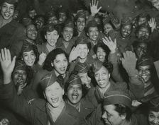A crowd of African American Women's Army Corps members waving at the camera..., 1946. Creator: Unknown