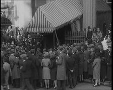 A Crowd of Civilians Gathering Under a Canopy Wearing Smart Outfits and Hats, 1920. Creator: British Pathe Ltd