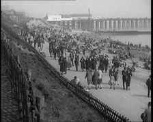 A Crowd of Civilians Sitting on Deckchairs at the Beach, 1926. Creator: British Pathe Ltd