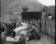 A Crowd of Civilians Watching a Group of Civilians Wheeling Malcolm Campbell's Bluebird .., 1927. Creator: British Pathe Ltd