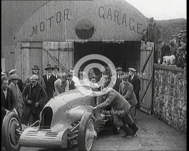 A Crowd of Civilians Watching a Group of Civilians Wheeling Malcolm Campbell's 'Bluebird'..., 1927. Creator: British Pathe Ltd.