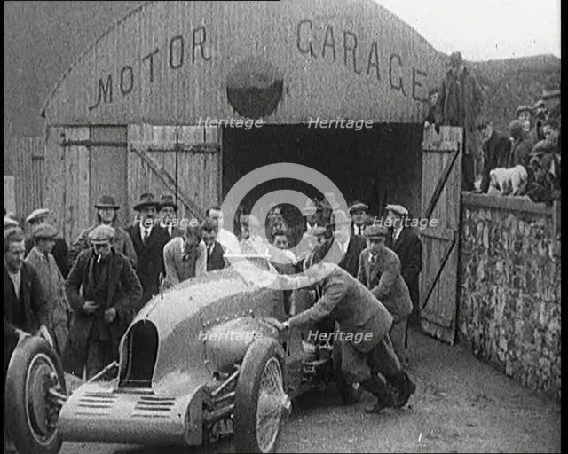 A Crowd of Civilians Watching a Group of Civilians Wheeling Malcolm Campbell's 'Bluebird'..., 1927. Creator: British Pathe Ltd.
