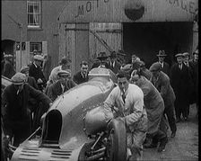 A Crowd of Civilians Watching a Group of Civilians Wheeling Malcolm Campbell's Bluebird .., 1927. Creator: British Pathe Ltd