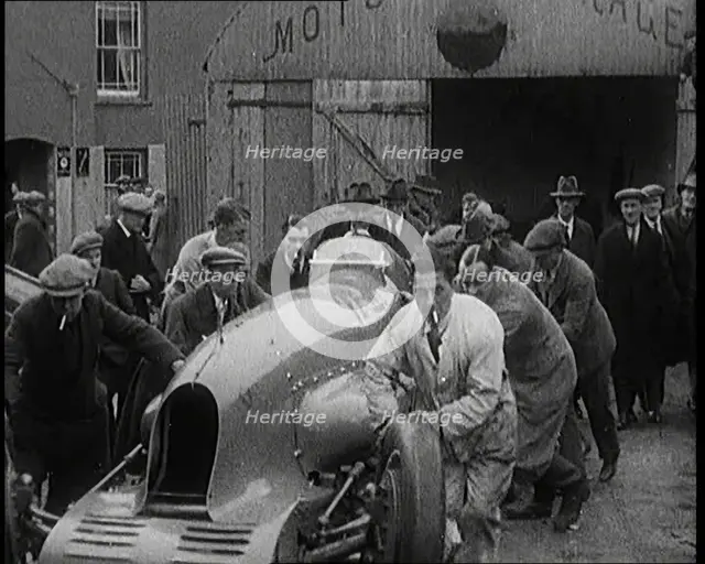 A Crowd of Civilians Watching a Group of Civilians Wheeling Malcolm Campbell's 'Bluebird'..., 1927. Creator: British Pathe Ltd.