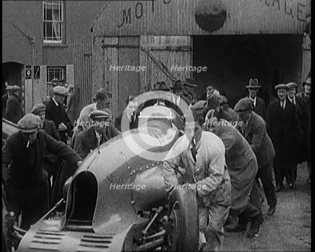 A Crowd of Civilians Watching a Group of Civilians Wheeling Malcolm Campbell's 'Bluebird'..., 1927. Creator: British Pathe Ltd.
