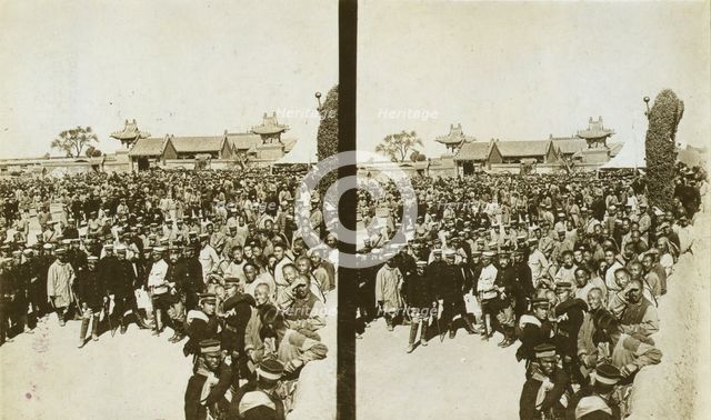 A crowd of Japanese soldiers; Chinese coolies in right foreground, Manchuria, c1905. Creator: Underwood & Underwood.