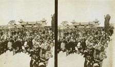 A crowd of Japanese soldiers; Chinese coolies in right foreground, Manchuria, c1905. Creator: Underwood & Underwood