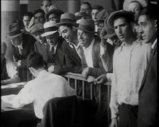 A Crowd of People Inside an Employment Agency Asking For Work, 1932. Creator: British Pathe Ltd
