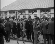 A Crowd of People Standing Outside a Totaliser/Tote Office at a Horse Race Course..., 1929. Creator: British Pathe Ltd