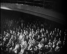 A Crowd of People Watching Acrobats on Stage in a Theatre, 1931. Creator: British Pathe Ltd