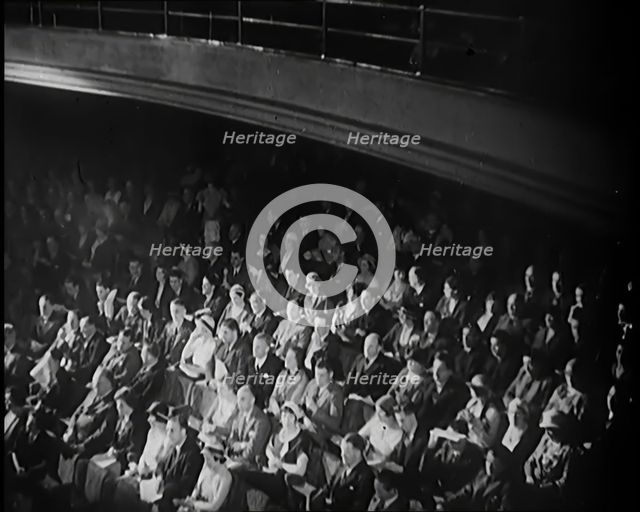 A Crowd of People Watching Acrobats on Stage in a Theatre, 1931. Creator: British Pathe Ltd.