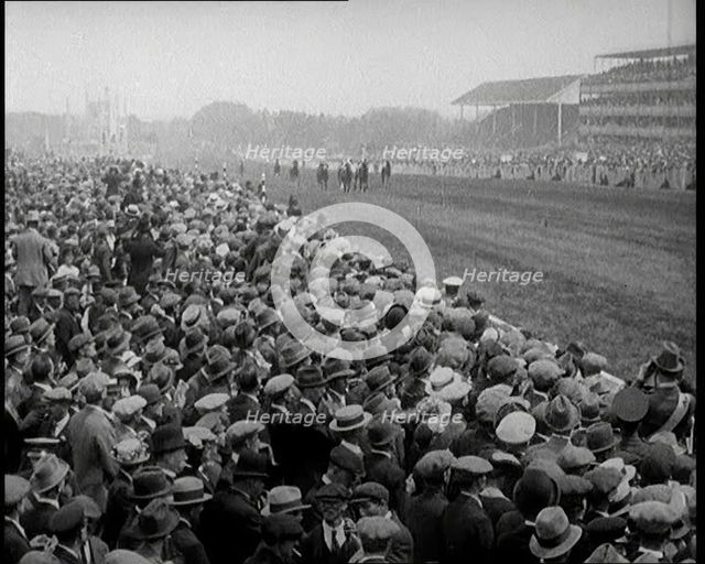 A Crowd of People Watching Horses Racing at Ascot Race Track, 1924. Creator: British Pathe Ltd.