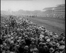 A Crowd of People Watching Horses Racing at Ascot Race Track, 1924. Creator: British Pathe Ltd
