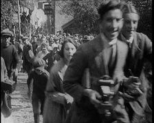 A Crowd Running up a Hilly Cobbled Street, 1920. Creator: British Pathe Ltd