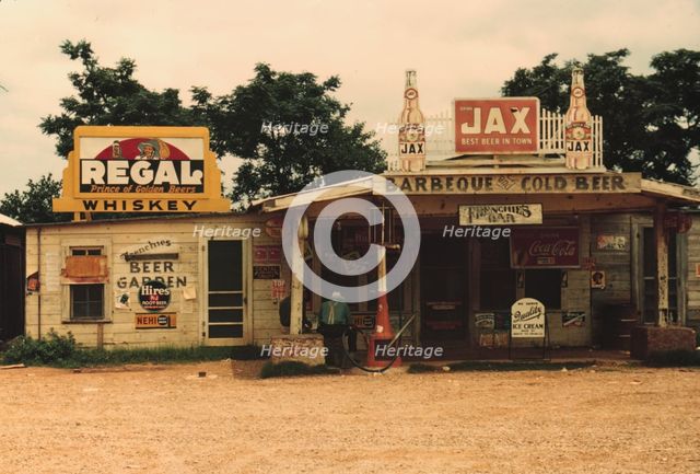 A cross roads store, bar, "juke joint," and gas...in the cotton plantation area, Melrose, La., 1940. Creator: Marion Post Wolcott.