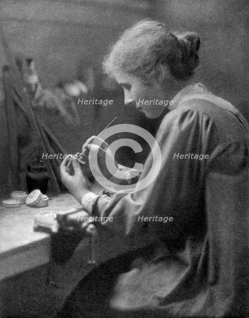 A craftswoman at work, 1911-1912.Artist: ET Holding