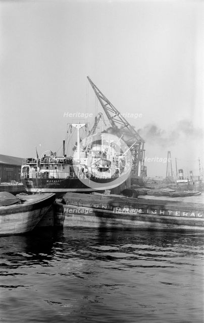 A crane unloading cargo from the 'Makalla' in Tilbury Docks, Essex, c1945-c1965. Artist: SW Rawlings