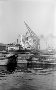 A crane unloading cargo from the Makalla in Tilbury Docks, Essex, c1945-c1965. Artist: SW Rawlings