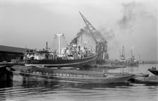 A crane unloads cargo from the Makalla in Tilbury Docks, Essex, c1945-c1965. Artist: SW Rawlings