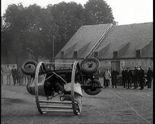 A Crashable Car With a Circular Frame Allowing It To Roll Over Being Tested in Front of..., 1926. Creator: British Pathe Ltd
