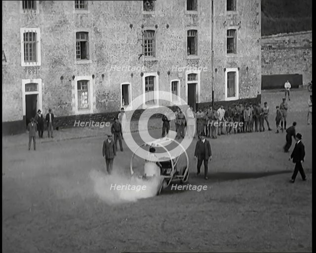 A Crashable Car With a Circular Frame Allowing It To Roll Over Being Tested in Front of..., 1926. Creator: British Pathe Ltd.