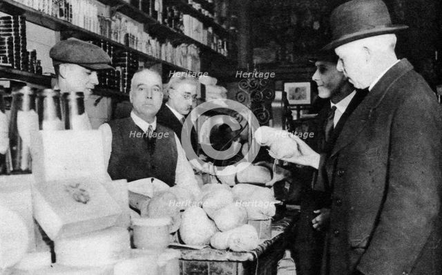 A customer inspects a haggis, London, 1926-1927. Artist: Unknown