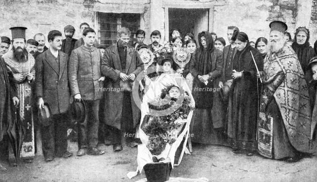 A dead Greek peasant lying in a coffin, 1922.Artist: HA Fawcett