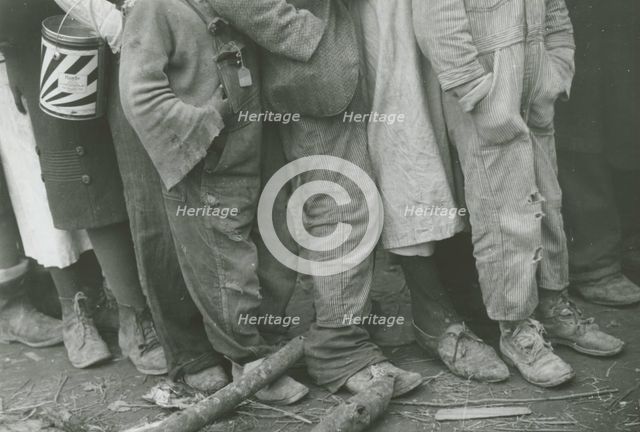 A detailed shot of flood refugees' feet showing their shoes; Forrest City, Arkansas, 1930s. Creators: Farm Security Administration, Walker Evans.