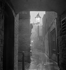 A dimly lit alley in London's theatre land off St Martin's Lane, early 1960s. Creator: John Gay
